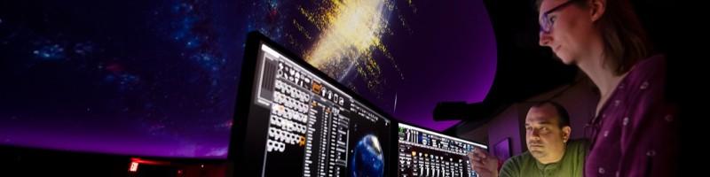 Wayne Schlingman in a planetarium with a colleague.