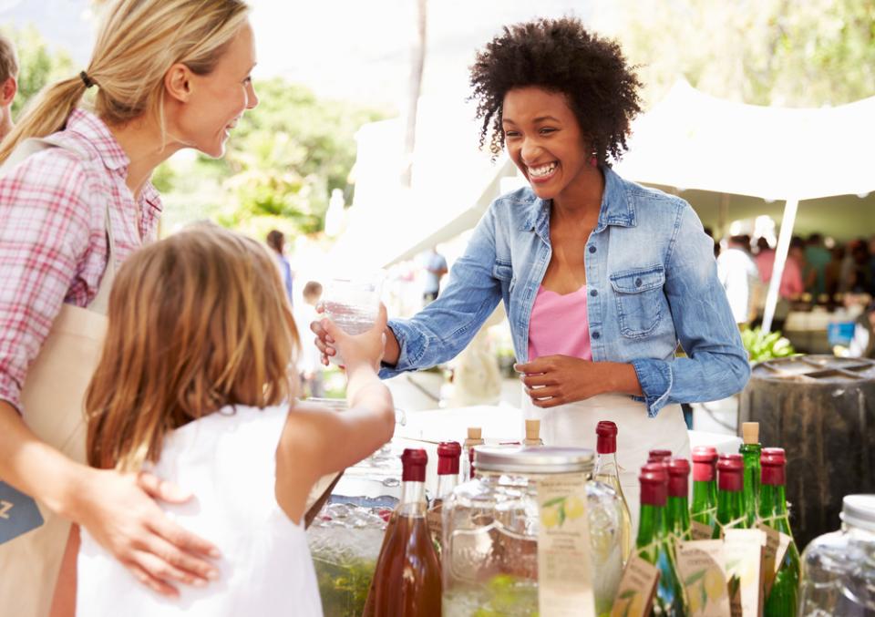 Woman selling drinks at Farmer's Market