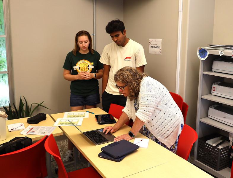 High school students work with a faculty member