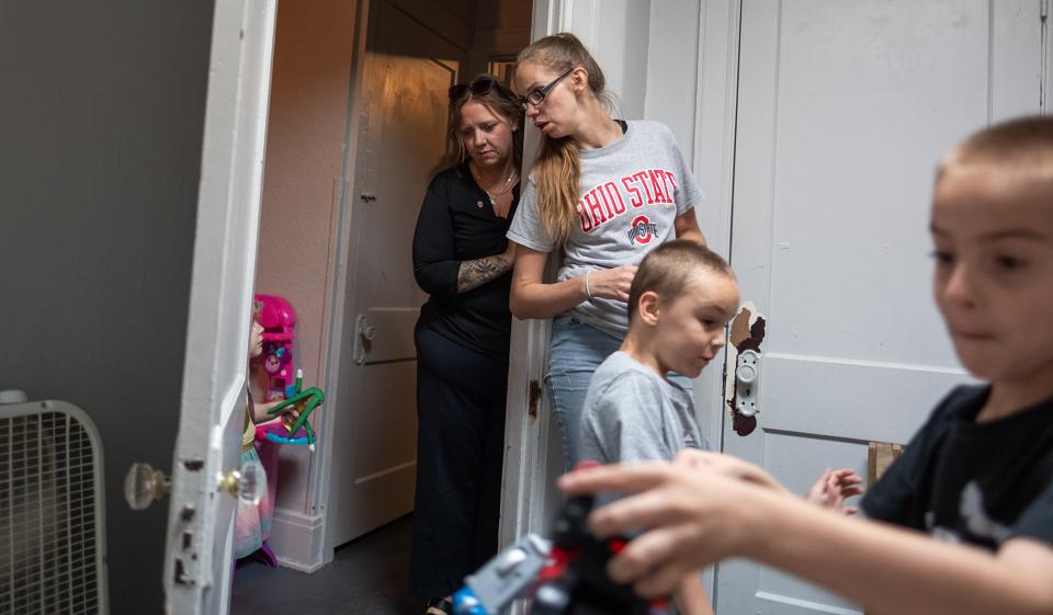 Elizabeth Helton (right) talks with OSU Extension team member Genesis Horstman while watching Elizabeth's children Sabrina, Carter and Alex put their toys away. (Corey Wilson)