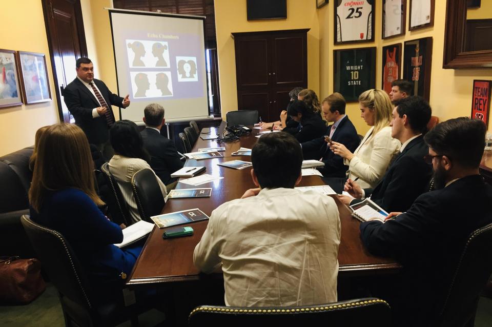 Michael Neblo speaking at a roundtable with twelve other people.