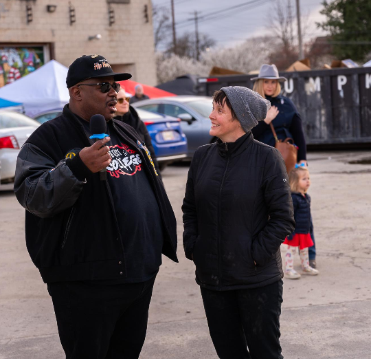 Charlene Brenner speaking with a man outside.