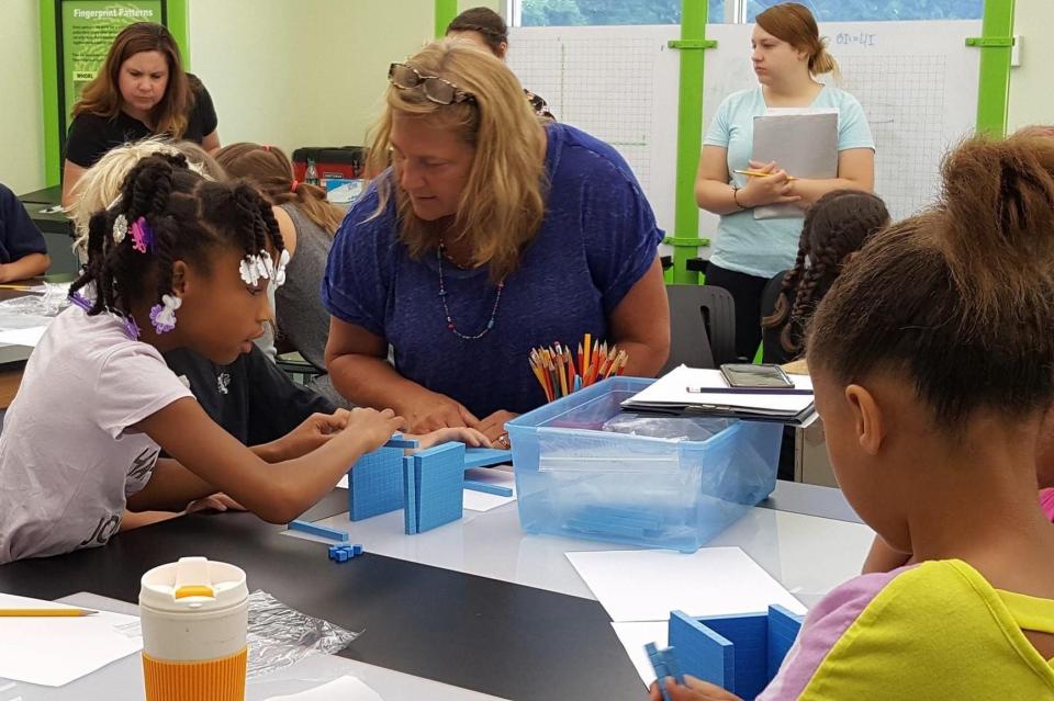 Terri Teal Bucci in a classroom teaching students.