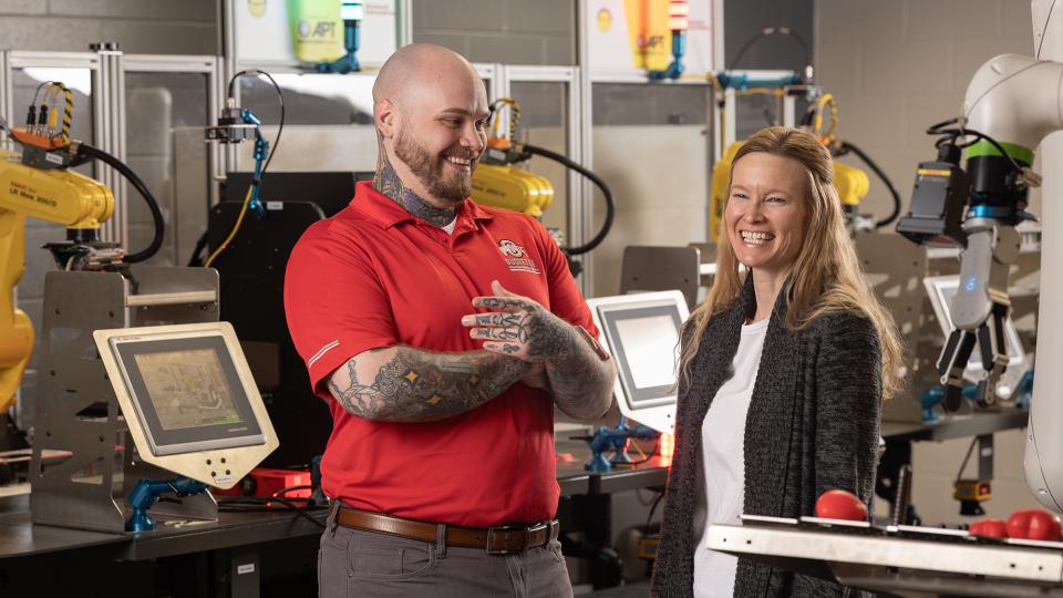Zack Ernest, left, catches up with his former professor Amber Rader in an engineering tech lab on the Mansfield campus. (Photo by Jodi Miller)