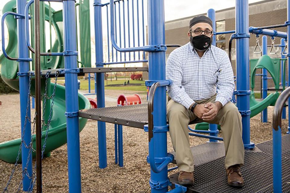 Ayaz Hyder sitting at a playground.